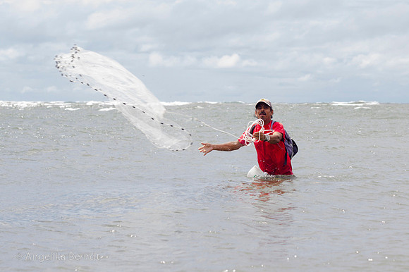 Fisherman fishing at the Pacific coast in Costa Rica